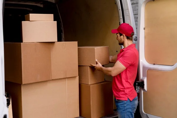 Men loading moving boxes and furniture into a truck