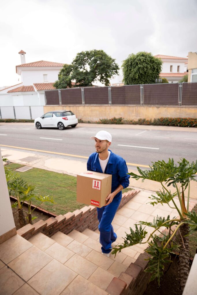 Local removalists giving boxes into a house