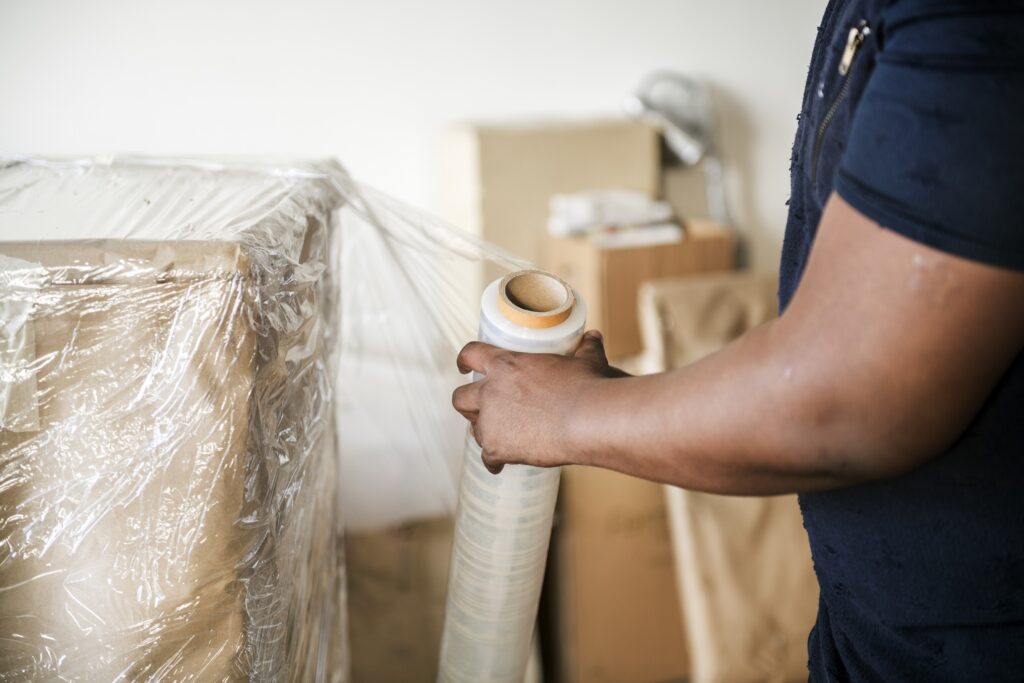 Person carrying boxes during a house removal