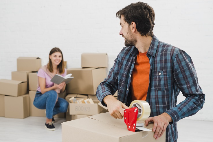 Packing belongings in corrugated boxes for moving from Sydney to Adelaide