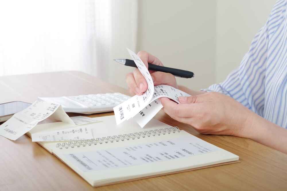 Woman Calculating Her Utility Bills in Hobart