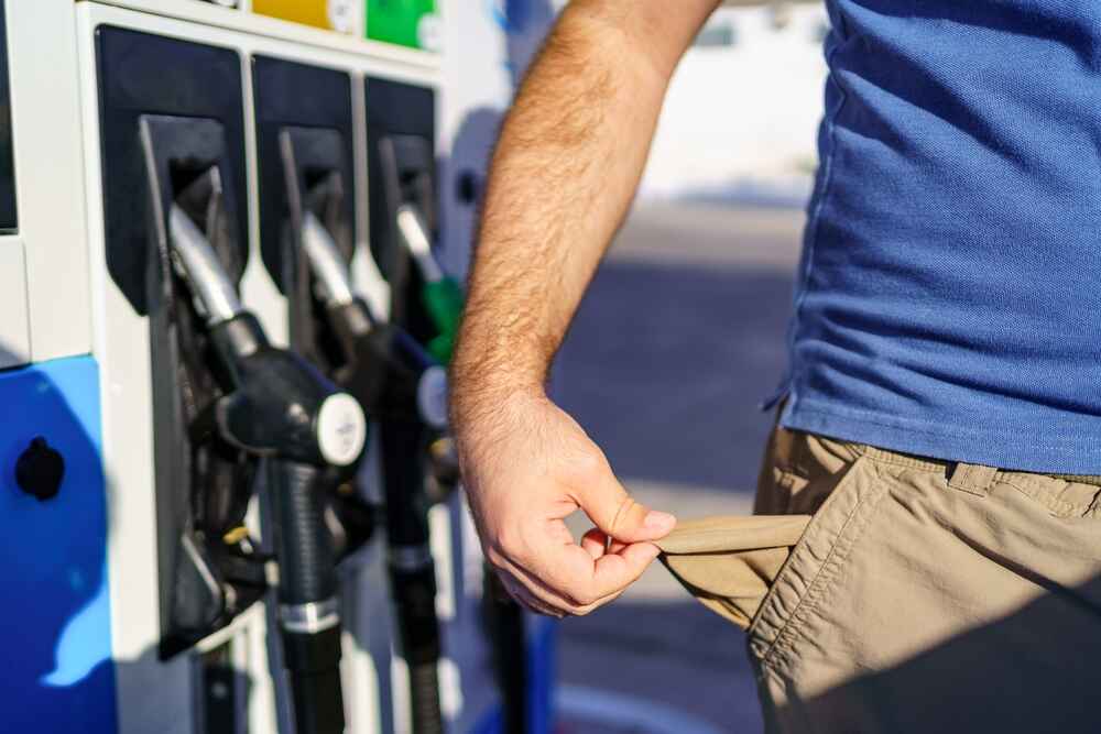Man Showing His Empty Pockets Because of Rising Fuel Prices