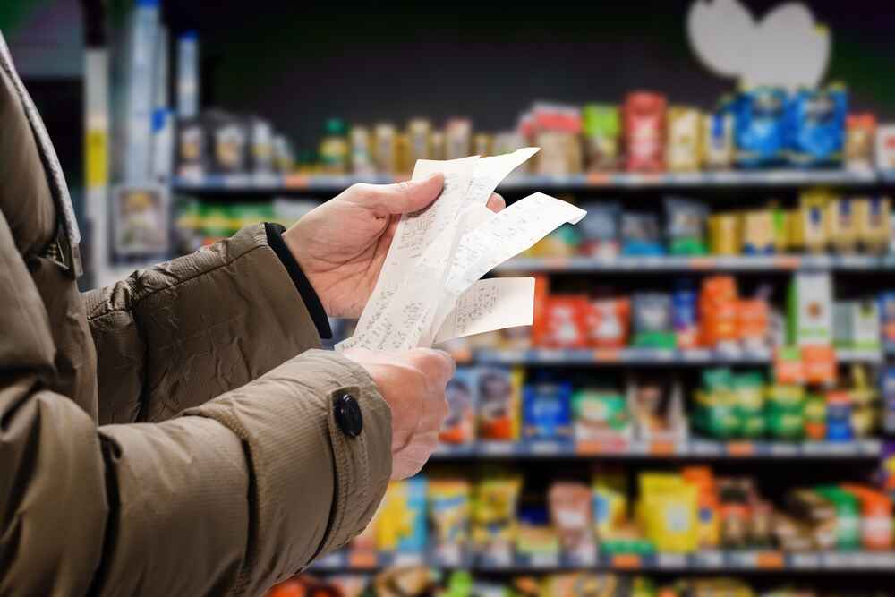 A Man Looking At His Grocery Bill In Perth