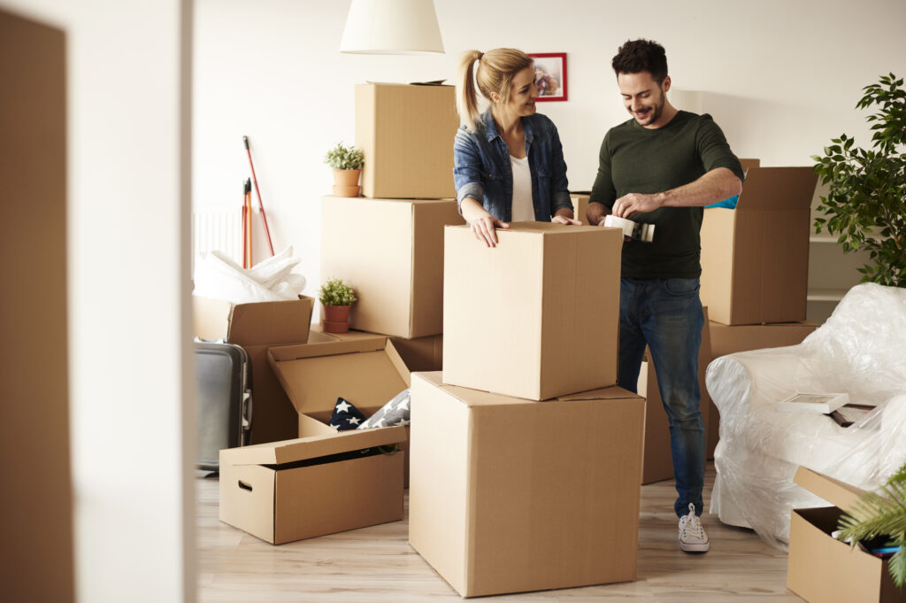 Man and Woman Packing Moving Boxes
