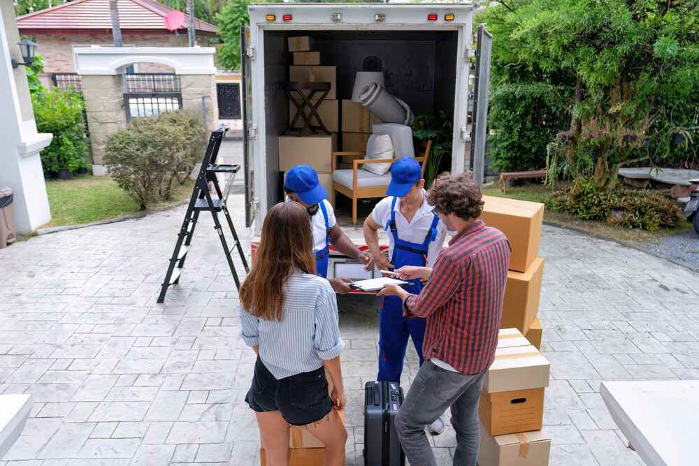 Professional Movers Unloading Boxes at Home